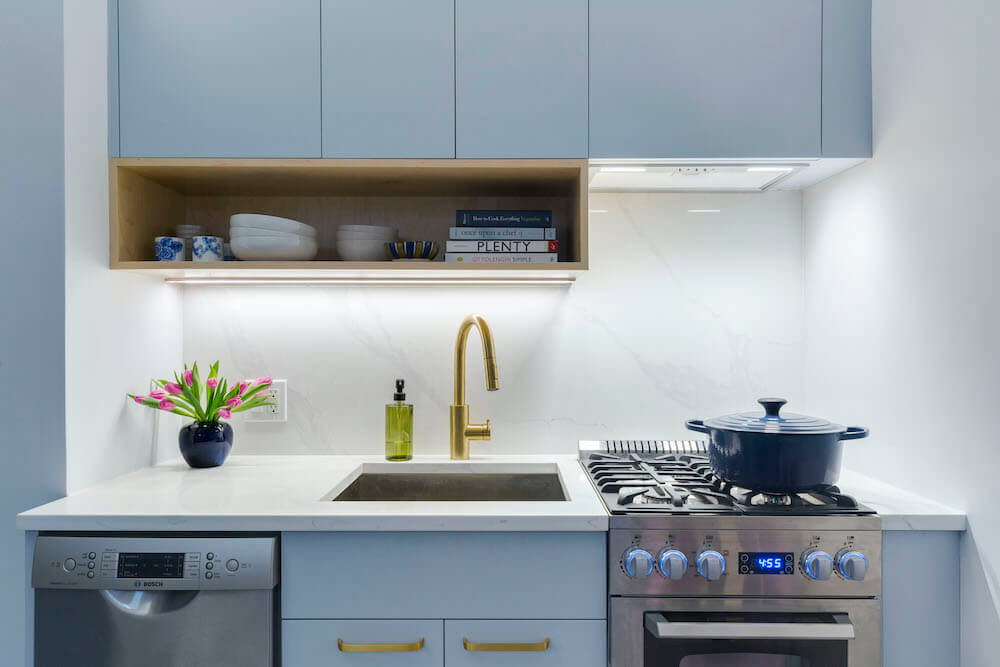 Image of a kitchen with brass finish fixtures 