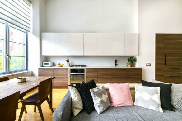 maple kitchen cabinets and white countertop and white overhead cabinets and open to dining and living spaces after renovation